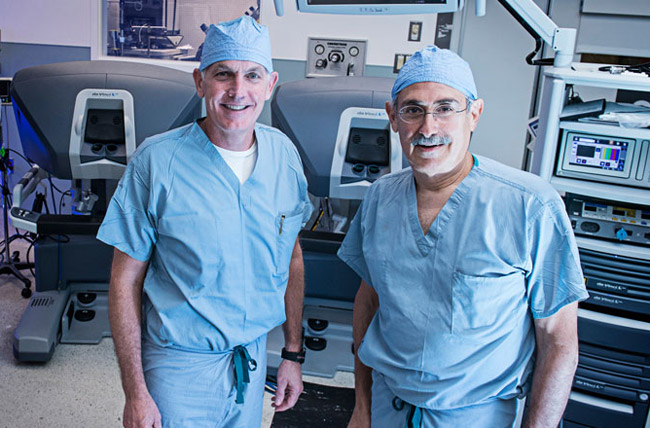 Dr. O'Malley and Dr. Weinstein standing by Otorhinolaryngology machine
